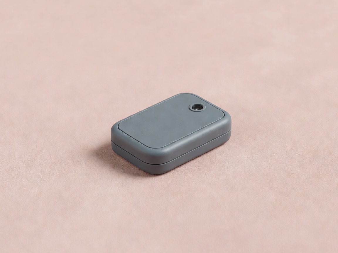 Generic soft-lit three-dimensional wildlife tracking tag on a plain blush background